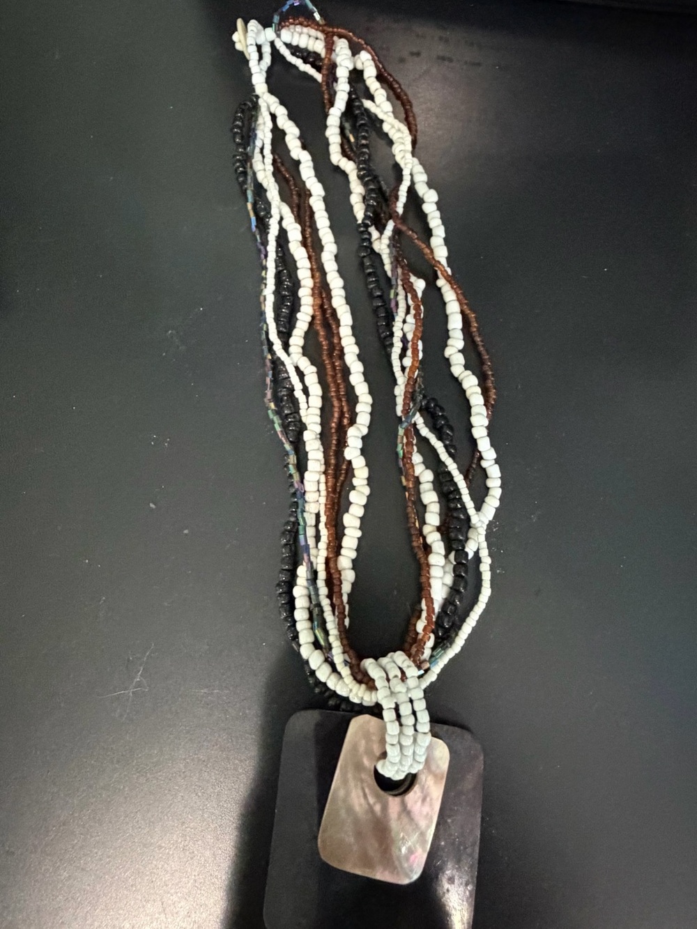 Multi-Strand Beaded Necklace with Black and White Shell Pendant